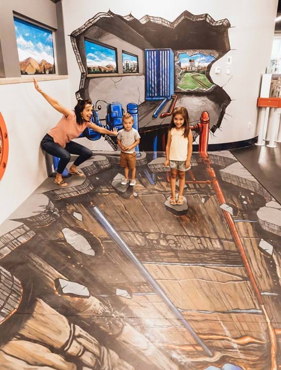 Family standing on a mural
