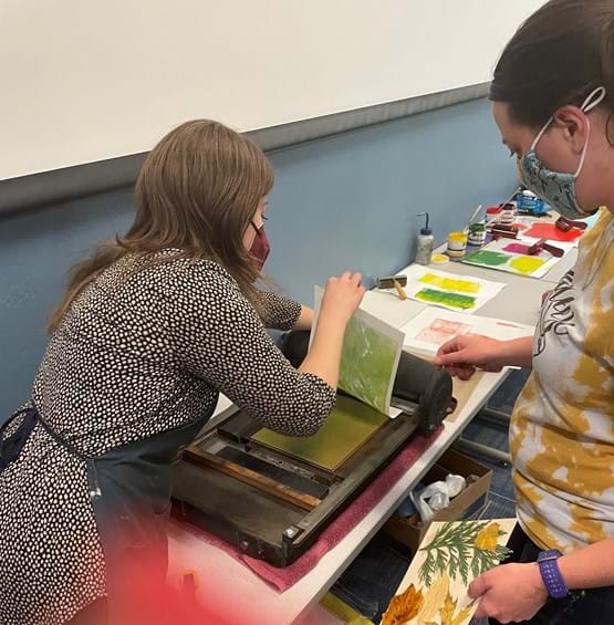 two adults doing artwork