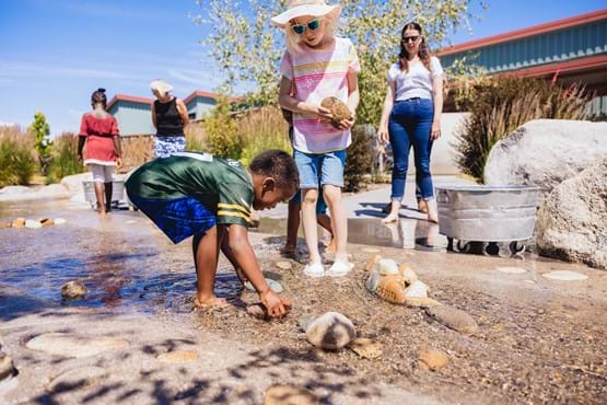 Outdoor River Campus with kids playing in the water