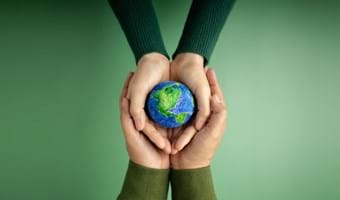 Hands holding model of earth