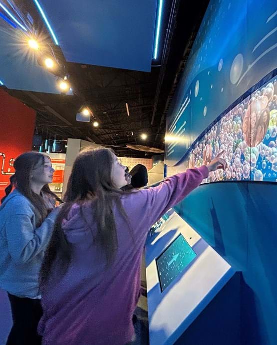 girls enjoying the interactive displays at the Boise Watershed